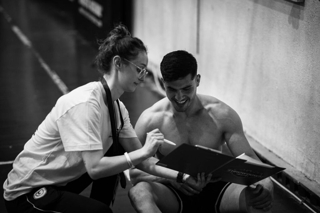 Female Trainer Instructing a Male Athlete